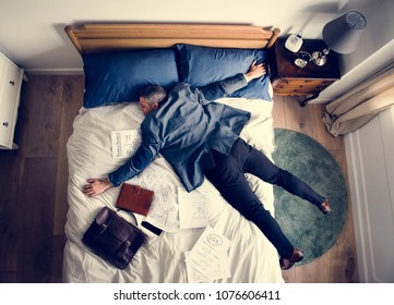 Exhausted business man falling asleep as soon as he came back home - Powered by Shutterstock