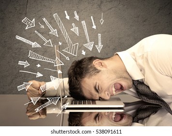 An exhausted business person resting his head keyboard and pressure illustrated by arrows pointing at him concept