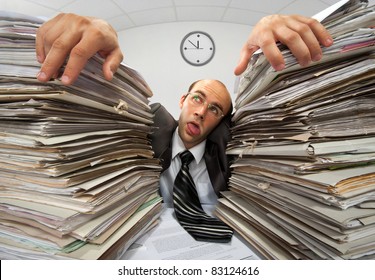 Exhausted businessman has had too much of his paperwork