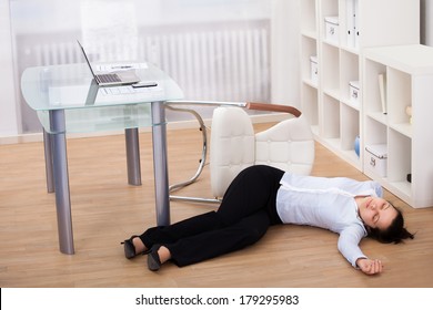 Exhausted Businesswoman Fainted On Floor At Workplace - Shutterstock ID 179295983