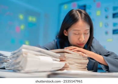 Exhausted businesswoman sleeping on desk at night, overwhelmed by work stress and deadlines, showing reality of burnout in corporate office - Powered by Shutterstock