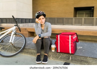 Exhausted Delivery Person Pedaled Many Miles In A Bike And Feeling Tired After Making A Lot Of Food Deliveries 