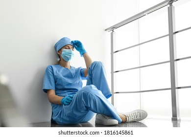 Exhausted doctor indoors. Stress of health care workers during COVID-19 pandemic - Powered by Shutterstock