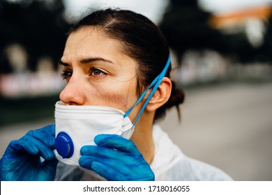 Exhausted Doctor/nurse Wearing Coronavirus Protective Gear N95 Mask Uniform.Coronavirus Covid-19 Outbreak.Mental Stress Of Frontline Worker.Face Scars.Mask Shortage.Overworked Healthcare Professional