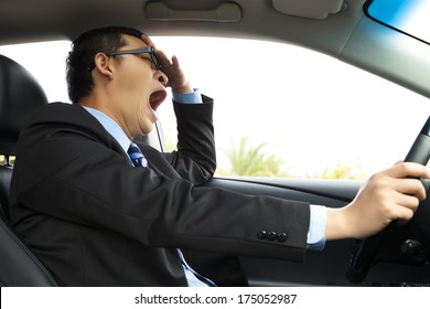 Exhausted driver yawning and driving  car  