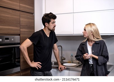 Exhausted Frustrated Wife Ignoring Angry Bearded Husband Arguing Blaming Upset Man Of Problems, Jealous Woman Shouting At Sad Male, Family Fight And Controlling Boyfriend, Disrespect. In Kitchen