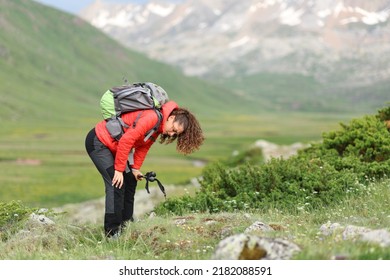 Exhausted Hiker In Red Resting In A High Mountain Field After Climbing