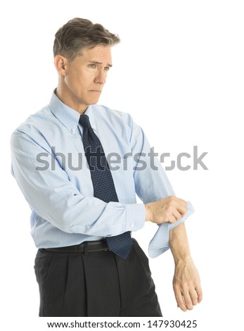Exhausted mature businessman rolling up his sleeves while standing isolated over white background
