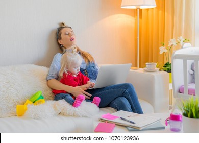 Exhausted mother fallen asleep in front of computer