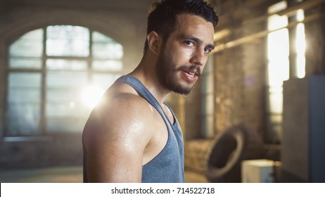 Exhausted Muscular Man Looking Into Camera After Exhausting Gym Workout. Sweat Is Dripping From His Face, He Wears Singlet.