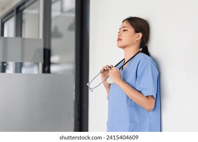 Exhausted Nurse Taking a Break in Hospital Hallway - Powered by Shutterstock