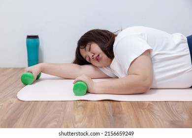 Exhausted Overweight Woman Lying On The Floor After Her Workout At Home