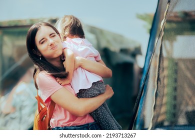 
Exhausted Overwhelmed Mom Holding Her Toddler Girl. Mother Embracing Emotional Daughter Comforting Her While Feeling Down
