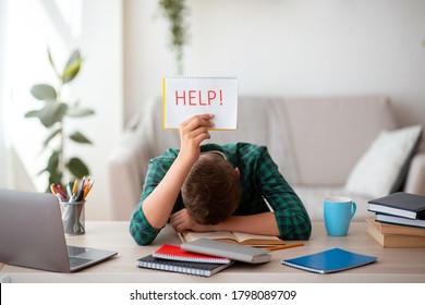 Exhausted schooler asking for help with help placard, studying online from home, difficulties of e-education - Powered by Shutterstock