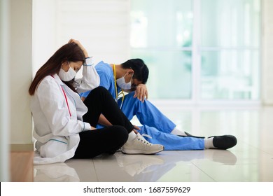 Exhausted tired Asian doctor or nurse. Virus outbreak in Asia. Coronavirus pandemic. Clinic and hospital medical stuff working over hours. Overworked professional. Stress and depression.
