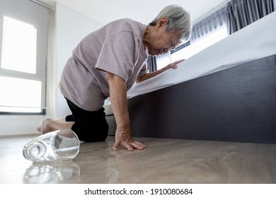 Exhausted Tired Asian Old Elderly Closed Her Eyes Having High Blood Pressure Headache,fatigue,vertigo,feel Dizzy,faint,fell On The Floor,senior Woman Trying To Help Herself Stand Up After Falling Down