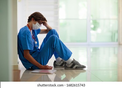 Exhausted Tired Doctor Or Nurse. Virus Outbreak. Coronavirus Pandemic. Clinic And Hospital Medical Stuff Working Over Hours. Overworked Professional. Stress And Depression.