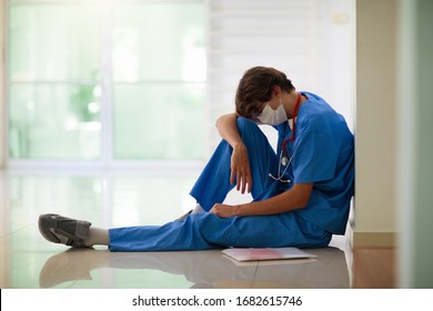 Exhausted Tired Doctor Or Nurse. Virus Outbreak. Coronavirus Pandemic. Clinic And Hospital Medical Stuff Working Over Hours. Overworked Professional. Stress And Depression.