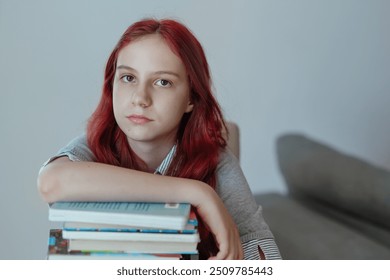 Exhausted tired girl teen sitting with hand on stacks of books looking at camera sadly and doomed, idea of fatique of exam preparation, overwork, troubles in learning, boredom, problems with homework - Powered by Shutterstock