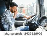 Exhausted truck driver falling asleep on steering wheel. Tiredness and sleeping concept.