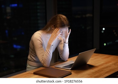 Exhausted Upset Young Woman Sit At Office Desk After End Of Workday Alone Massage Temples Trying To Remember Important Information. Stressed Tired Female Employee Feel Headache Caused By Work Overtime