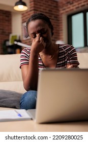 Exhausted Woman Having Migraine, Suffering From Painful Headache Symptom, Rubbing Nose Bridge With Fingers. Tired Person Feeling Unwell, Stressed Overworked Freelancer Sitting Near Laptop