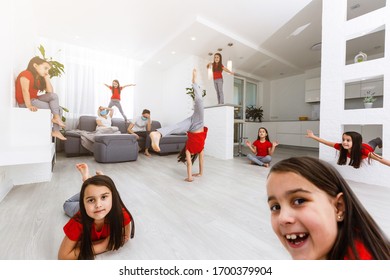 Exhausted Young Parents Sit On Couch In Kitchen Feel Unwell Tired From Ill-behaved Loud Little Children Running Playing, Sick Annoyed Mother Or Nanny Relax On Sofa Suffer From Headache,