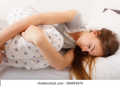 Exhaustion Relax Dreaming Sleep Concept. Tired Girl Sleeping. Young Lady Resting In Fetal Position Recovering In Bed.