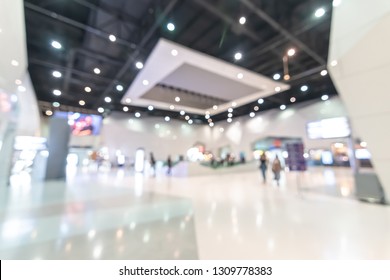 Exhibition event hall blur background of trade show business, world or international expo showcase, tech fair, with blurry exhibitor tradeshow booth displaying product with people crowd