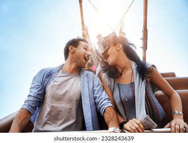 Exhilarated young couple on amusement park ride