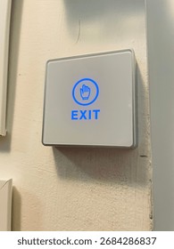 Exit button, causing the lights to transition from blue to green, which in turn allows for the door to open and grant exit