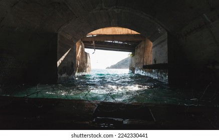 Exit gate of a concrete undergrounf tunnel, part of abandoned submarine base from USSR period located in Balaklava, Crimea