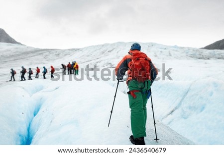 Exit Glacier ice hiking. People wearing ice crampons and walking on glaciers. Kenai Fjords National Park. Alaska.