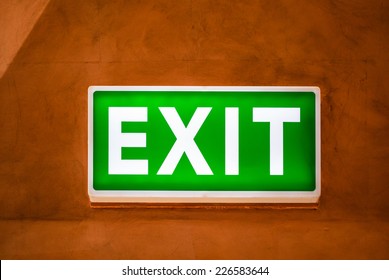 Exit light box on golden wall
