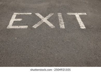 Exit painted on tarmacasphalt at a car park exit