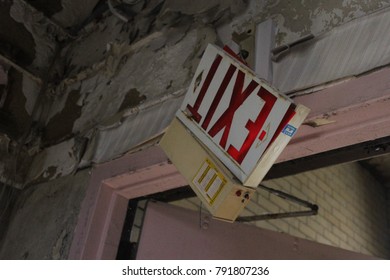 Exit Sign In Interior Of Old Abandoned Mental Asylum Hospital Building