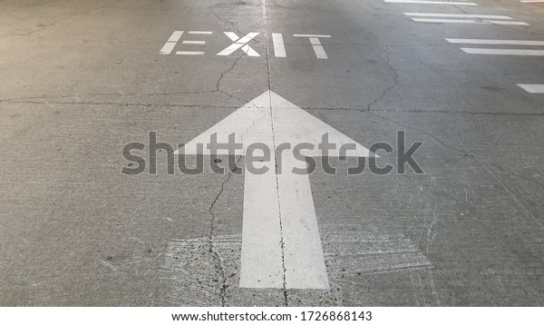 Exit sign on the\
driveway in parking garage
