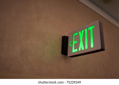 Exit sign points the way out of building at the airport