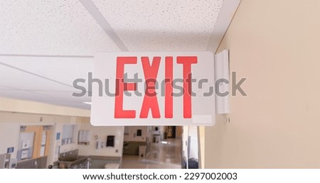 exit sign in red and white color signifies a way out or emergency exit. It is an essential safety feature in public and commercial buildings, providing clear and visible guidance to people 