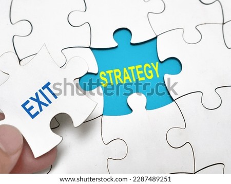 Exit strategy, text words typography written under jigsaw puzzle, life and business motivational inspirational concept