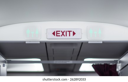 Exit And Toilet Sign On Plane