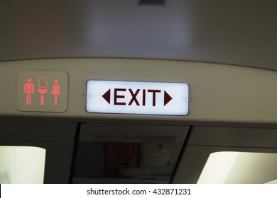 Exit And Toilet Sign On Plane