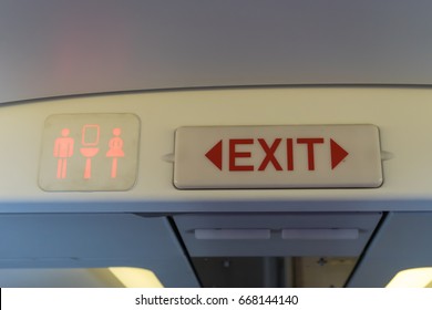 Exit And Toilet Sign On Plane