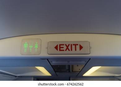 Exit And Toilet Sign On Plane