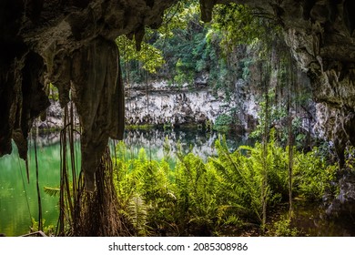 Exit from the water cave in the jungle to a small lake surrounded by mountains. Beautiful tropical nature.
