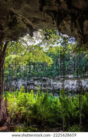 Exit from the water cave in the jungle to a small lake surrounded by mountains. Beautiful tropical nature. Cave with access to the water in the tropics.
