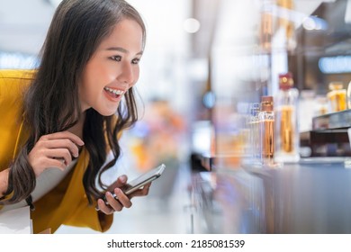 Exited Asian Female Woman Looking Close For Choosing Cosmetic Perfume Display On Shelf With Pleasure In Shopping Mall Department Store,happiness Asian Woman Shopping With Joyful Moment Lifestyle