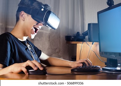 Exited Child Playing Games On Computer Using VR Glasses 