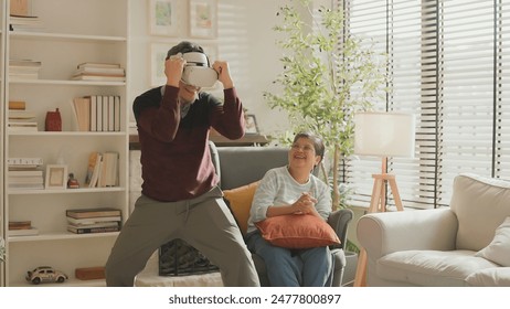 exiting asian senior old man white beard enjoy virtual augmented reality metaverse explore online digital world game in living room at home,casial relax old man play digital leisure game at home  - Powered by Shutterstock