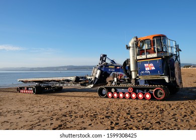 Exmouth, Devon/UK- December 25 2019: The RNLI Supacat Tractor and Carriage waiting to haul Exmouth's Shannon-class lifeboat back into their lifeboat station at Exmouth beach
